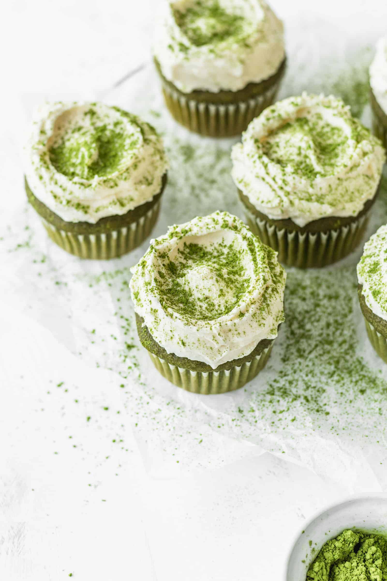 Fluffy white chocolate frosting on matcha green tea cupcakes