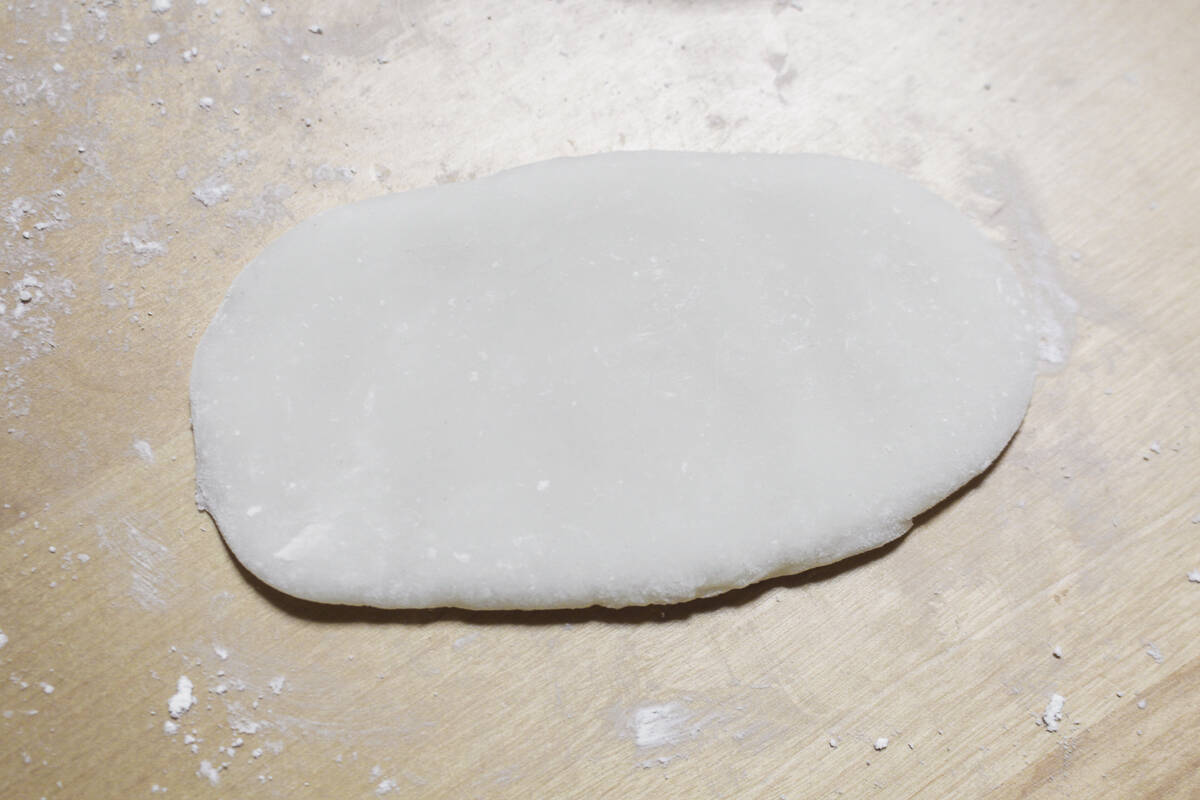 Rolling out the mochi dough into an oblong shape.