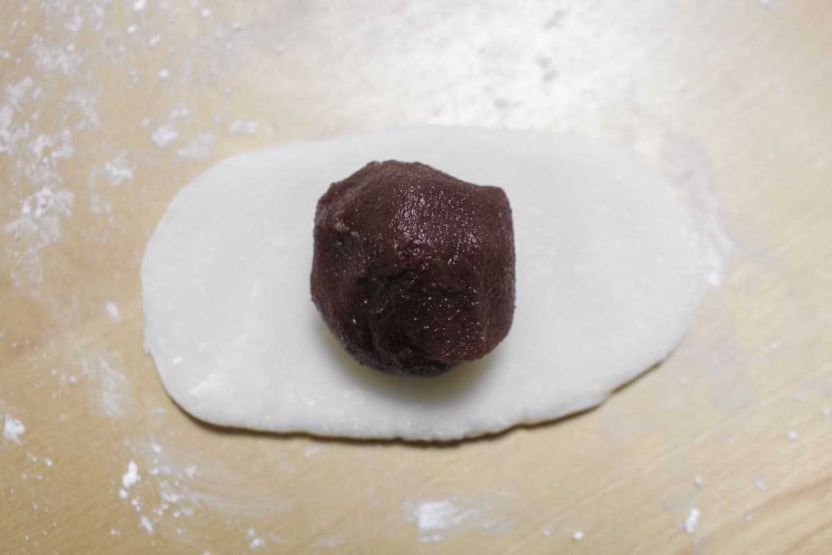 Red bean paste added to the center of the rolled out mochi.