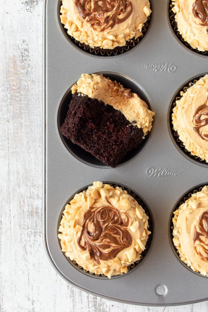 A muffin pan with chocolate peanut butter cupcakes.
