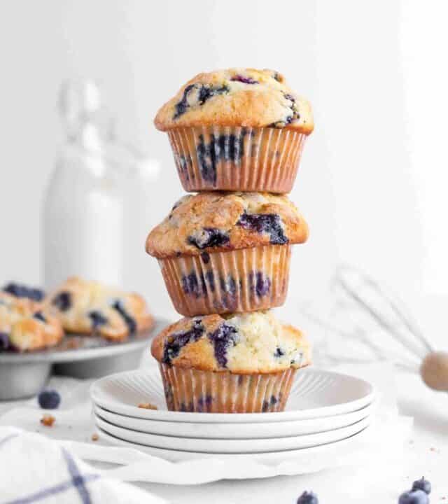Blueberry muffins stacked on a plate