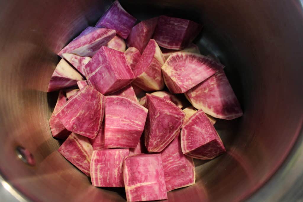 Japanese purple sweet potatoes, chopped and ready to be boiled