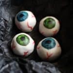 These Halloween white chocolate eyeballs have a surprise filling: purple sweet potato! A much healthier option for trick or treating kids on Halloween! #Halloween #HappyHalloween #healthy #whitechocolate #chocolate #truffle #purple #black #sweetpotato #eyeball #eyeballs #trickortreat #kids