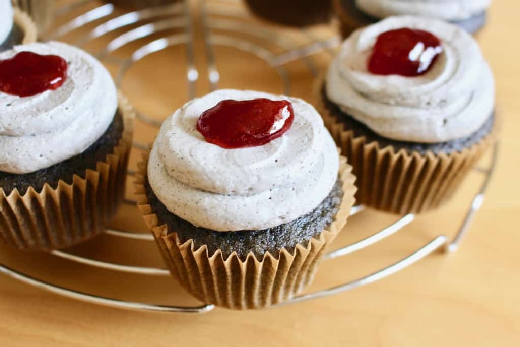 Frosted black cupcakes with a dollop of fake blood