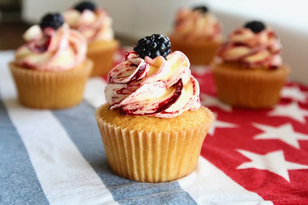 These corn cupcakes are jam packed with corn! There’s corn in the fluffy cupcakes, and corn in the silky buttercream frosting, kissed with tart and fruity blackberries! It’s the perfect cupcake to serve at your Fourth of July BBQ! #corn #corncupcakes #cornmuffins #cornfrosting #frosting #buttercream #blackberry #blackberries #fourthofjuly #fluffy #moist #4thofjuly #independenceday #bbq #barbecue #july #summer