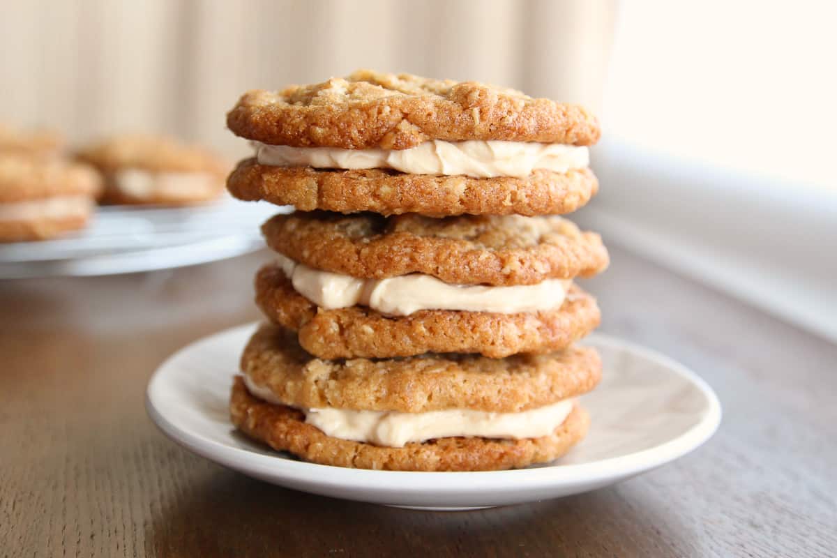 A stack of oatmeal cream pie cookies on a small dessert plate.