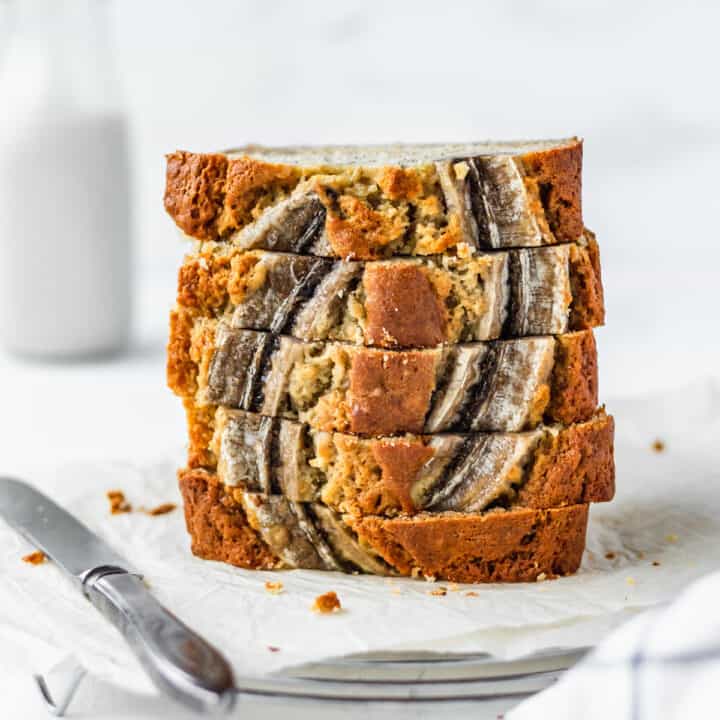 A stack of moist banana bread with a white background.