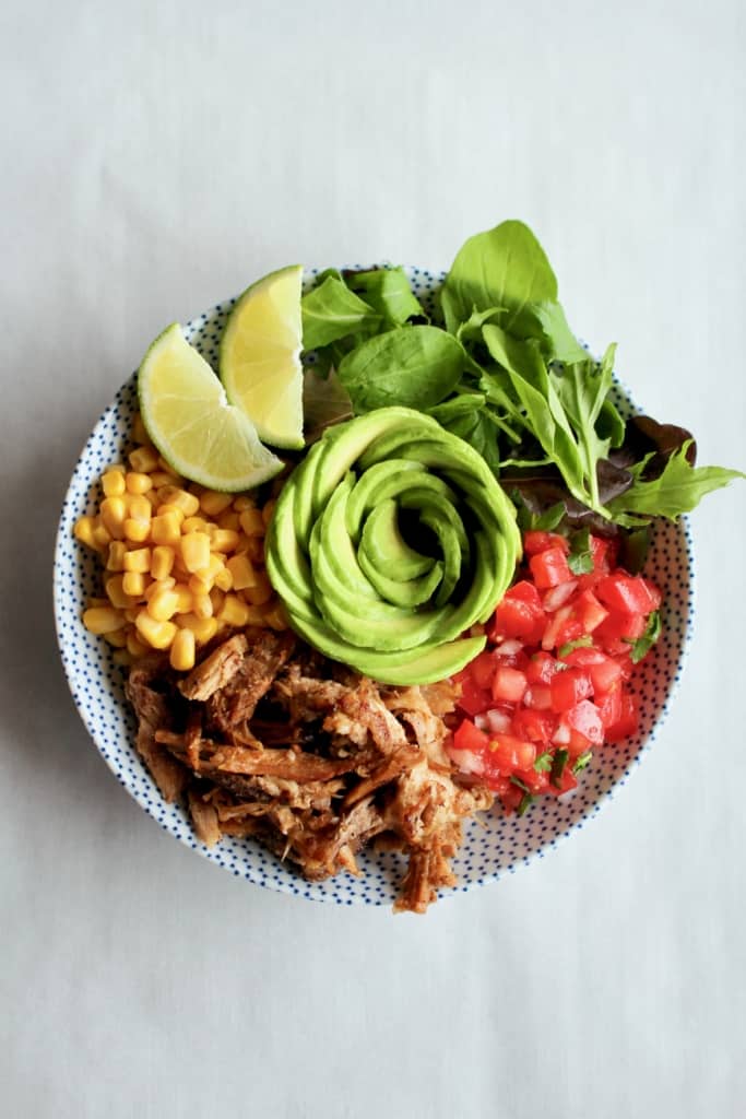 This is THE BEST slow cooker carnitas! So easy to make, yet so tender, crispy, and full of flavor! #carnitas #slowcooker #crockpot #pulledpork #porkshoulder #porkbutt #mexican #mexico #orange #garlic #onions #spices #cilantro #lime #avocado #tacos #arepas #salad #ricebowl #pasta