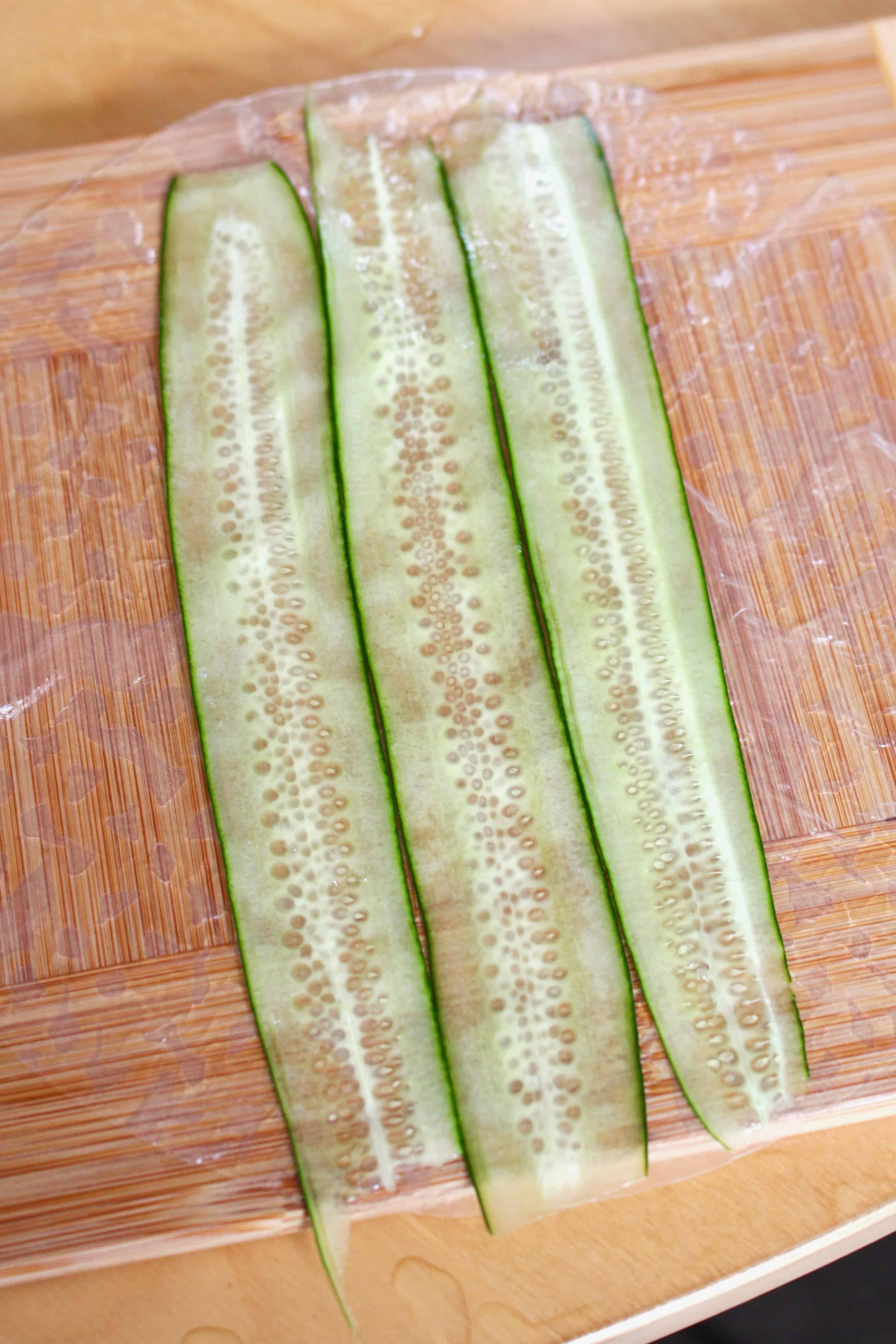 Sliced cucumbers laid on rice paper.