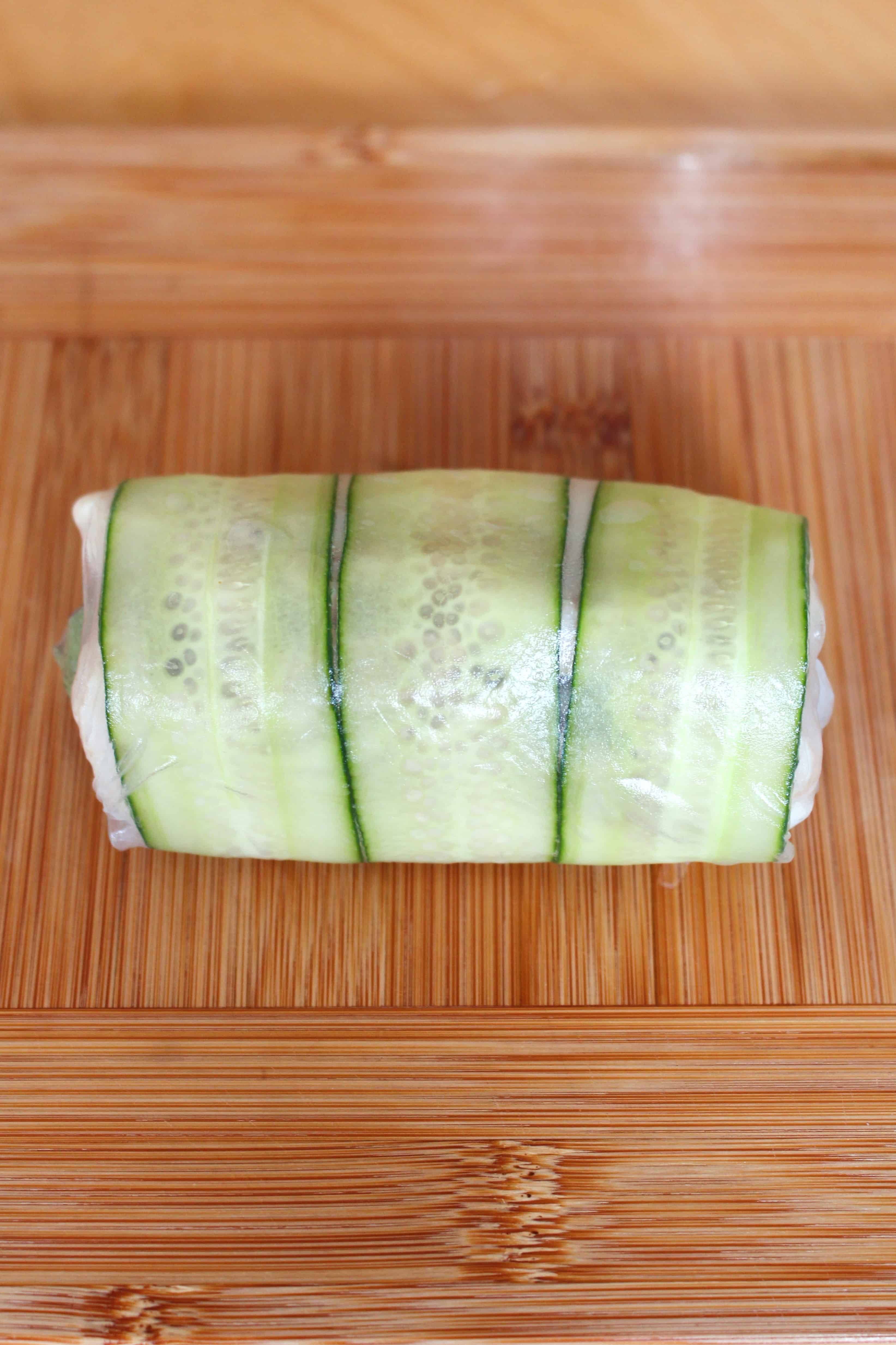 Fresh spring roll on a wooden surface.