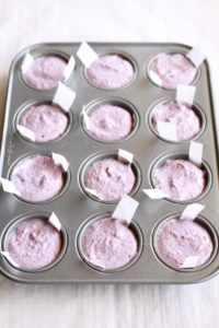 Mini muffin pan filled with vegan cheesecake batter.
