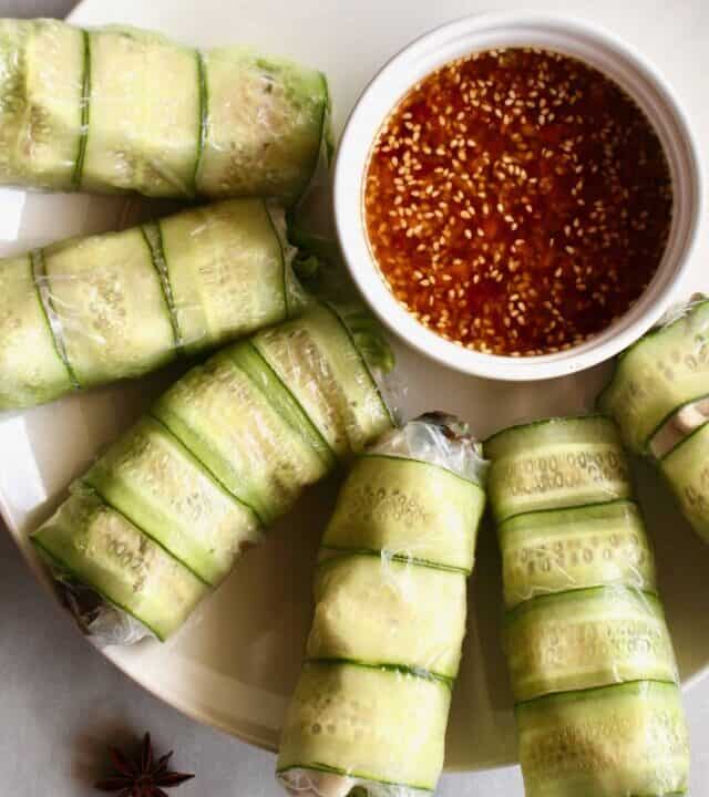 Need a fresh and light appetizer? These spicy chicken summer rolls are perfect! Moist and flavorful chicken is wrapped in rice paper with lettuce and cucumber, served with a spicy Sichuan dipping sauce! #summerrolls #springrolls #ricepaper #chicken #chickenthigh #chinese #sichuan #spicy #healthy #lettucewraps #appetizer #fresh #light #partyfood #asian