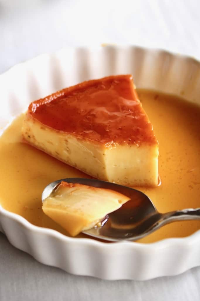 A slice of Filipino leche flan with a spoon
