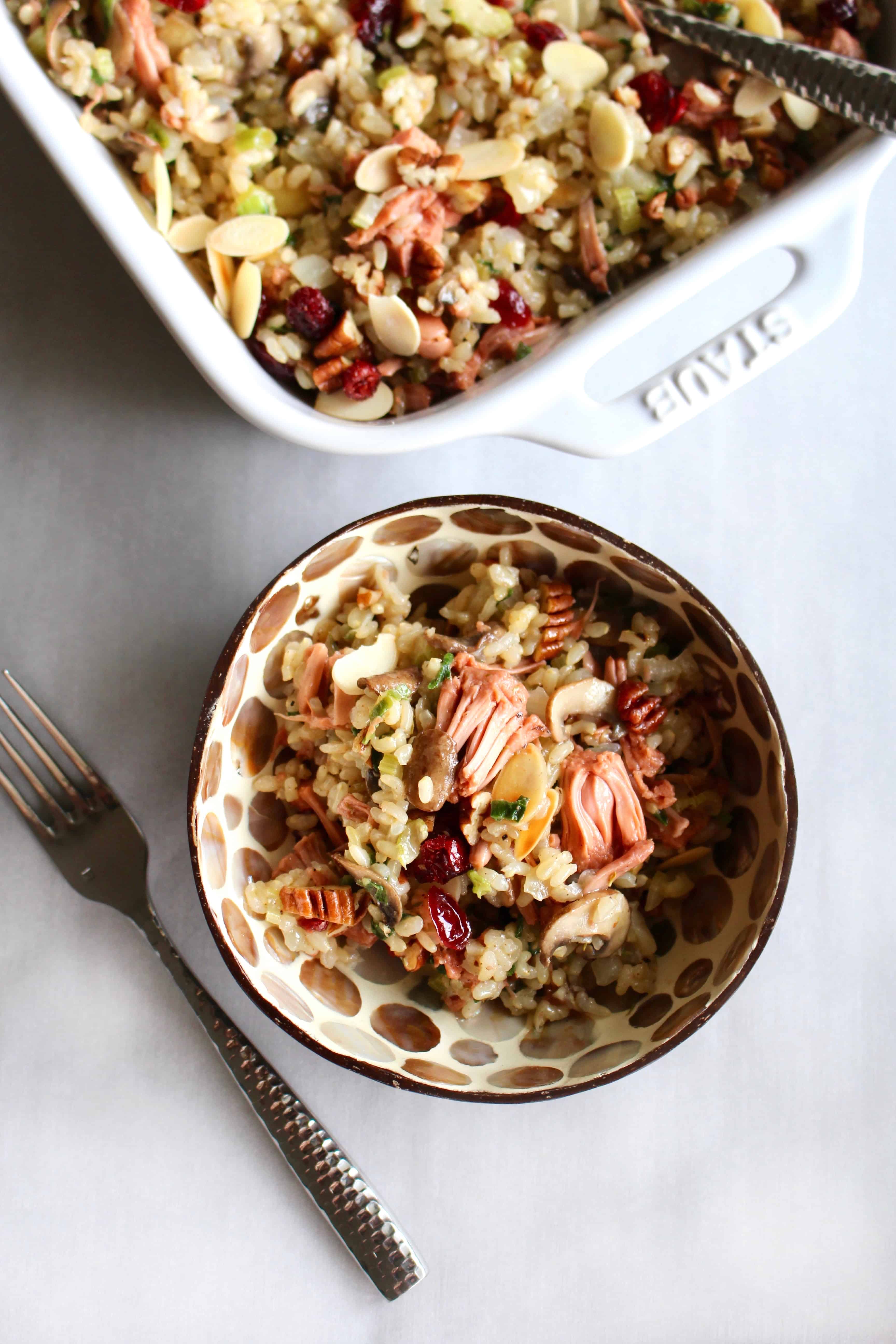 This rice stuffing with jackfruit is truly THE BEST stuffing ever! It’s both vegan and gluten free so everyone can enjoy it, making it perfect for the holidays when you have guests with different dietary restrictions. Full of brown rice, vegetables, cranberries, nuts, and jackfruit confit, there’s so much flavor in this stuffing you won’t be missing the meat! This is sure to be your new go to stuffing recipe for Thanksgiving and Christmas! #rice #ricestuffing #stuffing #thanksgiving #christmas #dinner #glutenfree #vegan #vegetarian #brownrice #easy #jackfruit #meatsubstitute #meatless #holidays #fall #winter #recipe #beststuffing #cranberries #almonds #pecans