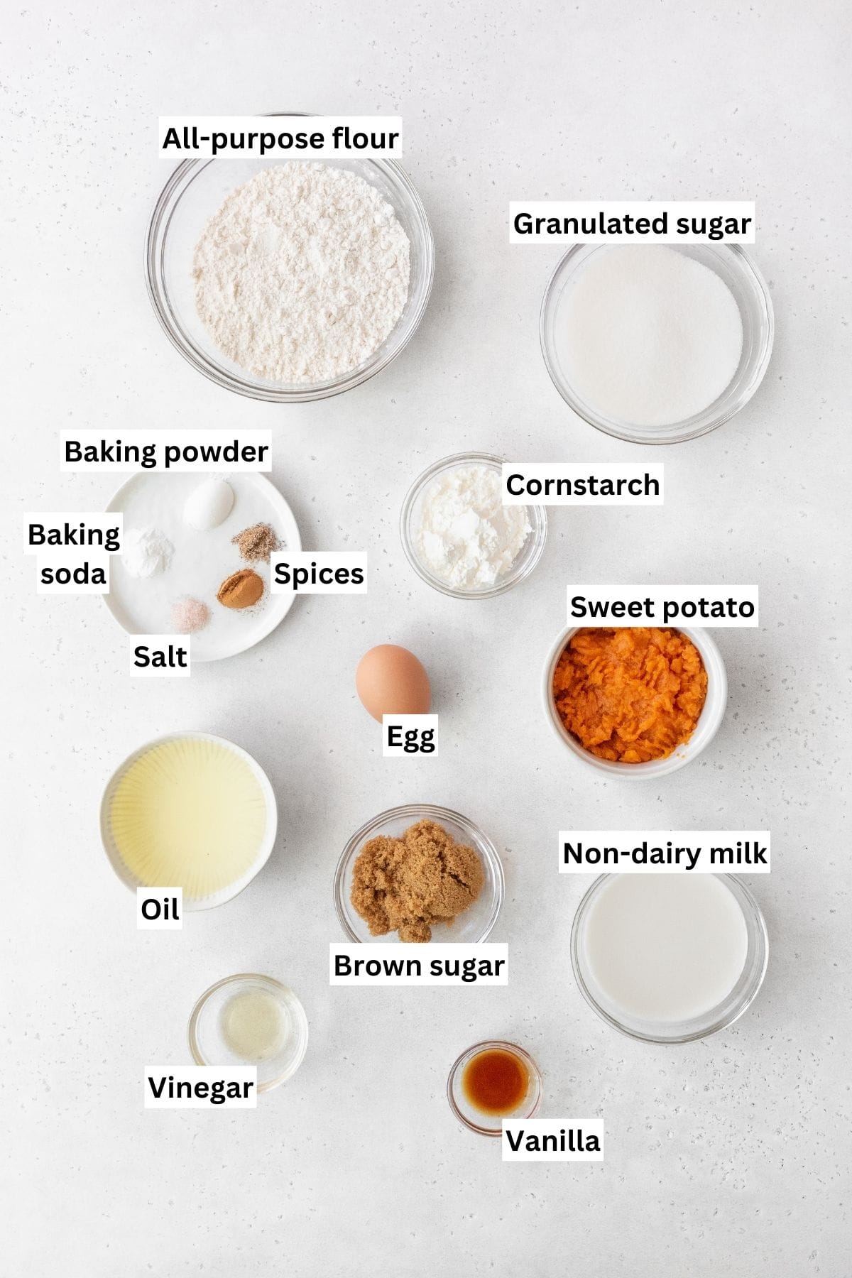 Overhead shot of sweet potato cake ingredients measure out into bowls.