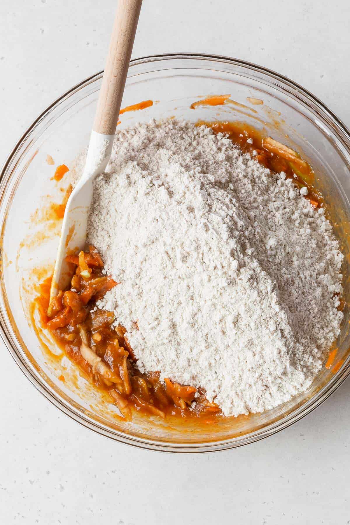 Process shot - dry ingredients added to bowl with wet ingredients.