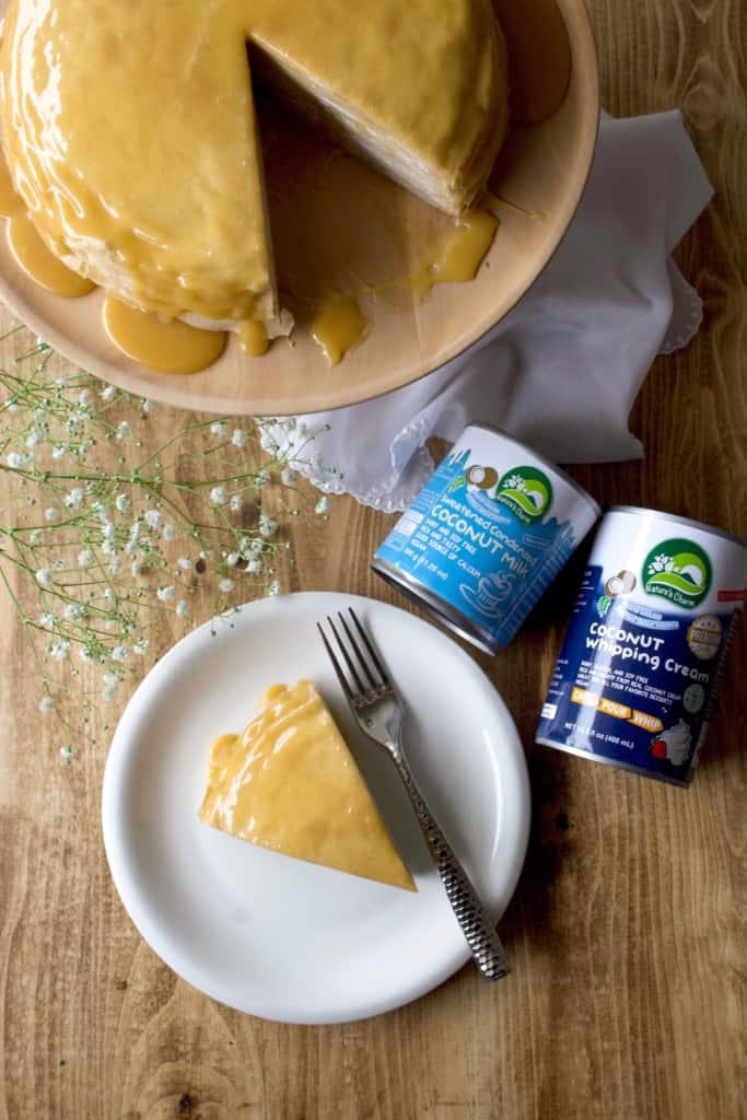 Coconut whipped cream sandwiched between layers of delicious crêpes, then topped with rich homemade dulce de leche! Whether you call it gâteau de crêpes, mille crêpe, or crepe cake, this is a beautiful and impressive dessert! #french #crepecake #crepes #pancakes #gateau #millecrepe #dulcedeleche #coconut #dairyfree #condensedmilk #caramel #cake