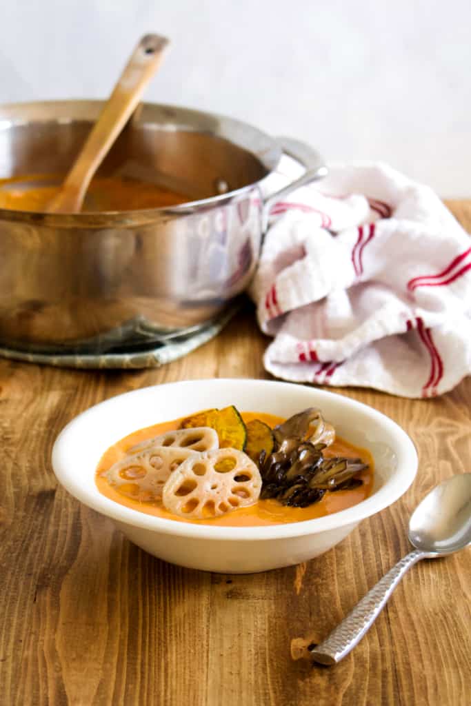 Vegan coconut curry is creamy, spicy, and is sure to keep you warm this winter! Full of vegetables, it’s so much better tasting, and better for you, than takeout! #vegan #coconutmilk #coconutcurry #curry #indiancurry #thaicurry #winter #rootvegetables #vegetables #delicious #comfortfood #recipe #spicy #creamy #glutenfree #lotusroot #kabocha #maitake #mushrooms