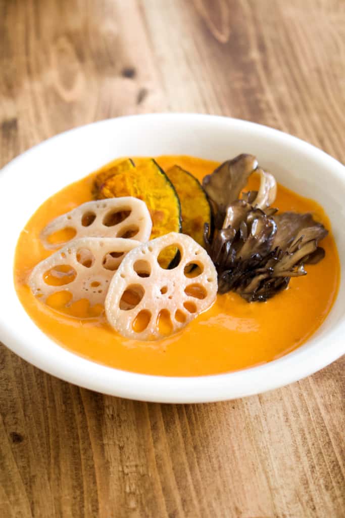 Vegan coconut curry is creamy, spicy, and is sure to keep you warm this winter! Full of vegetables, it’s so much better tasting, and better for you, than takeout! #vegan #coconutmilk #coconutcurry #curry #indiancurry #thaicurry #winter #rootvegetables #vegetables #delicious #comfortfood #recipe #spicy #creamy #glutenfree #lotusroot #kabocha #maitake #mushrooms