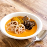 Vegan coconut curry is creamy, spicy, and is sure to keep you warm this winter! Full of vegetables, it’s so much better tasting, and better for you, than takeout! #vegan #coconutmilk #coconutcurry #curry #indiancurry #thaicurry #winter #rootvegetables #vegetables #delicious #comfortfood #recipe #spicy #creamy #glutenfree #lotusroot #kabocha #maitake #mushrooms