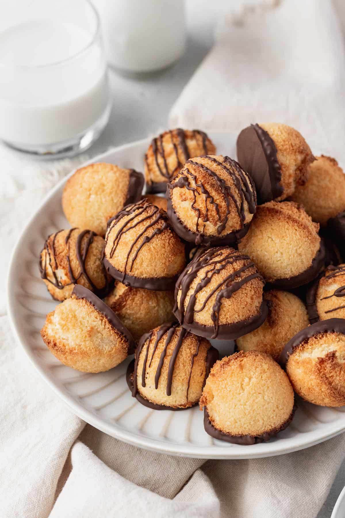 A white plate of the dairy-free macaroons on top of a napkin.
