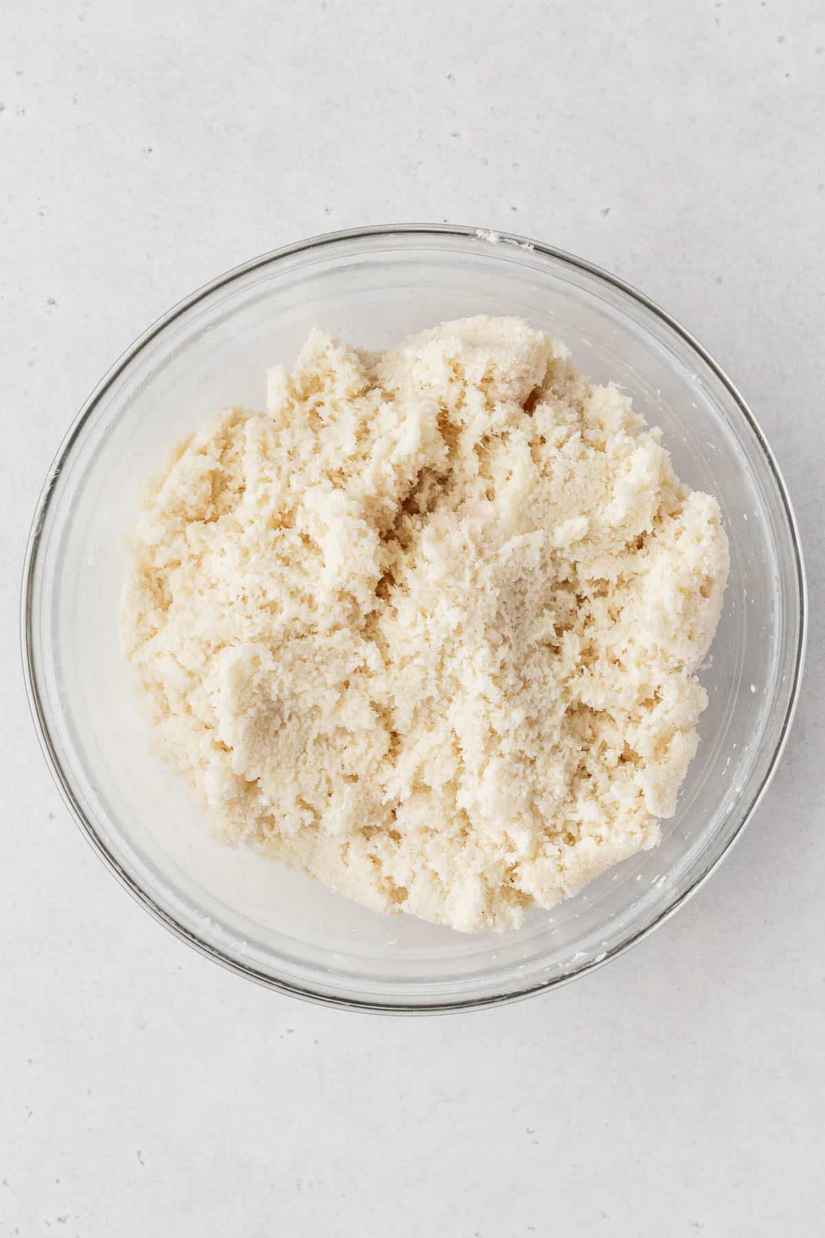 Vegan coconut macaroon dough in a glass bowl.