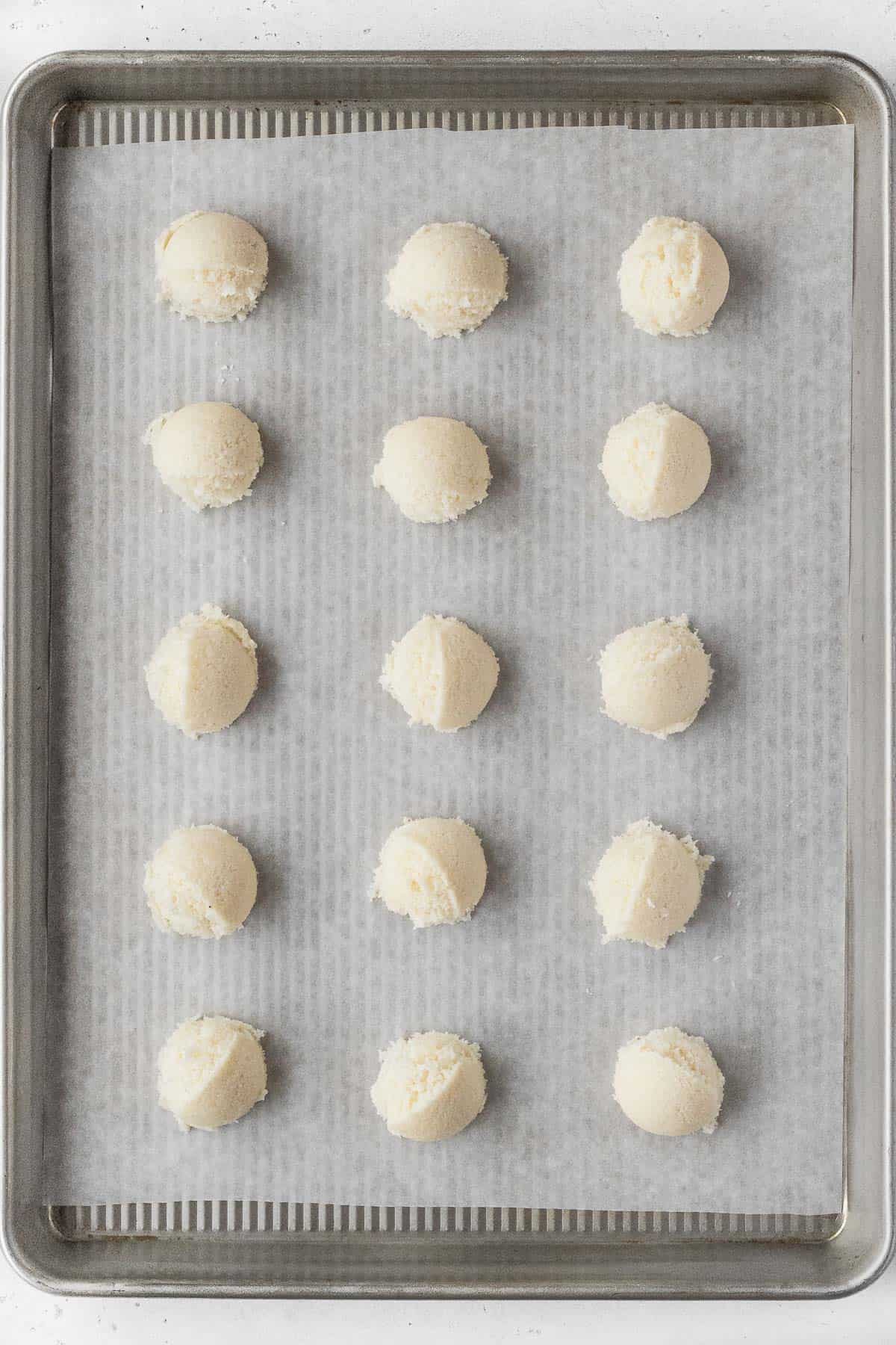 Vegan macaroon dough on a parchment paper lined baking sheet.