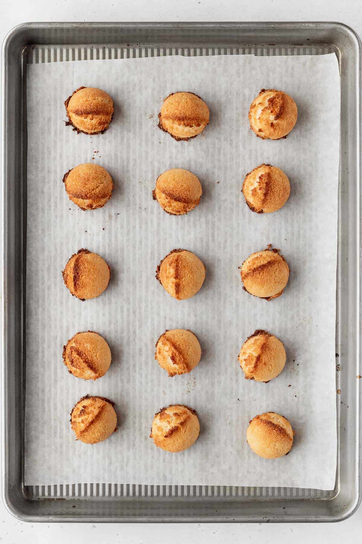 Vegan coconut macaroons after baking and still on the baking sheet.