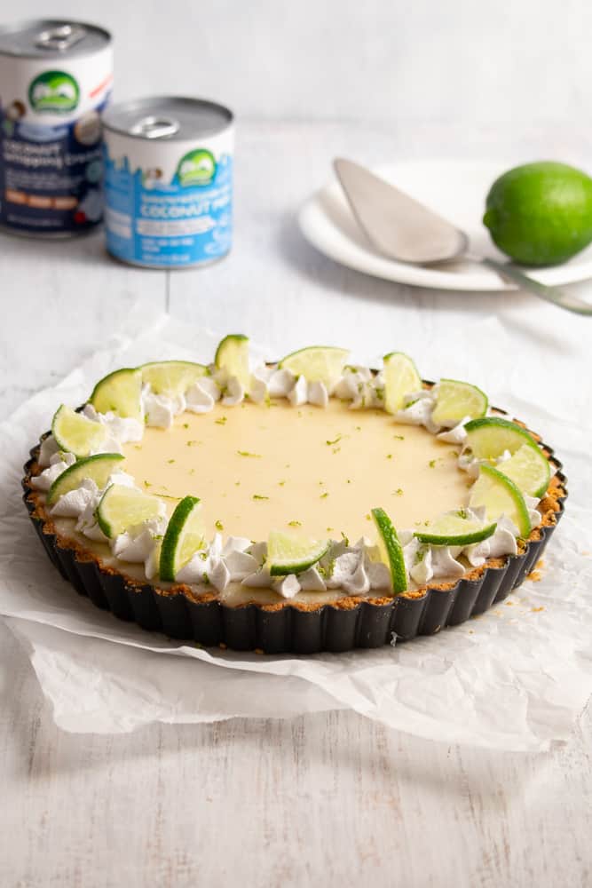 This vegan key lime pie is so creamy and tangy! With a crunchy graham cracker crust on the bottom and topped with rich coconut whipped cream, this plant based dessert won’t have you missing the traditional key lime pie! #vegandessert #vegankeylimepie #keylimepie #nobakedessert #nobakepie #plantbaseddessert