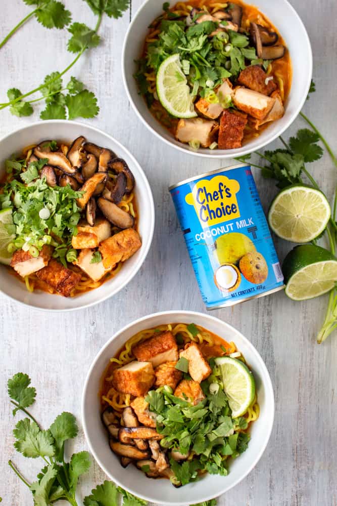 This vegan Thai red curry ramen is your new go-to quick and easy comfort food! Red curry paste and coconut milk make the perfect spicy and creamy soup for ramen noodles, deep fried tofu, and sautéed shiitake mushrooms. The scallions, cilantro, and lime juice tie it all together in this vegan fusion deliciousness! #veganrecipe #veganramen #thairedcurry #currypaste #coconutmilk
