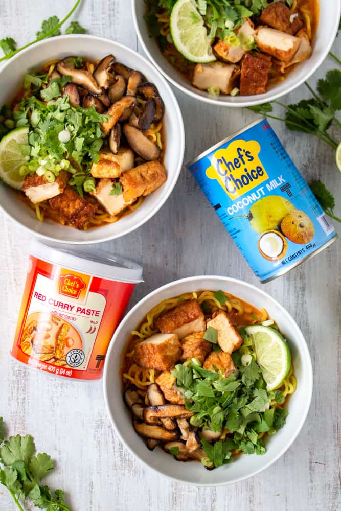 This vegan Thai red curry ramen is your new go-to quick and easy comfort food! Red curry paste and coconut milk make the perfect spicy and creamy soup for ramen noodles, deep fried tofu, and sautéed shiitake mushrooms. The scallions, cilantro, and lime juice tie it all together in this vegan fusion deliciousness! #veganrecipe #veganramen #thairedcurry #currypaste #coconutmilk
