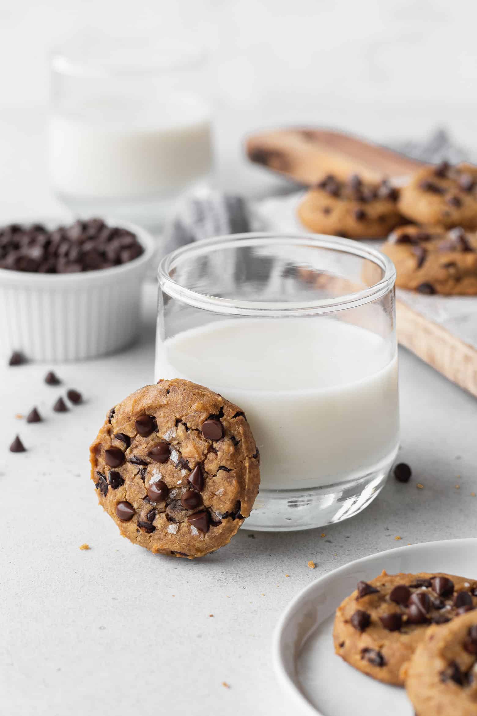 Chocolate chip cookie leaning on a glass of milk