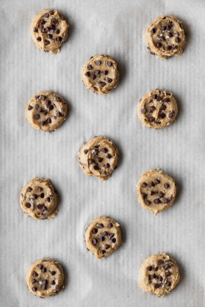 Chocolate chip cookie dough on a baking sheet