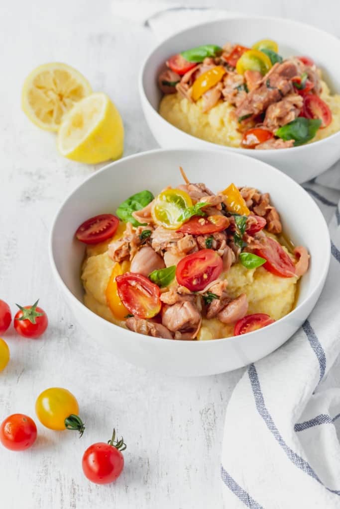 This vegan grits recipe is the perfect gluten-free meal! Creamy vegan polenta cooked in coconut milk is topped with savory jackfruit confit with tomatoes and basil!