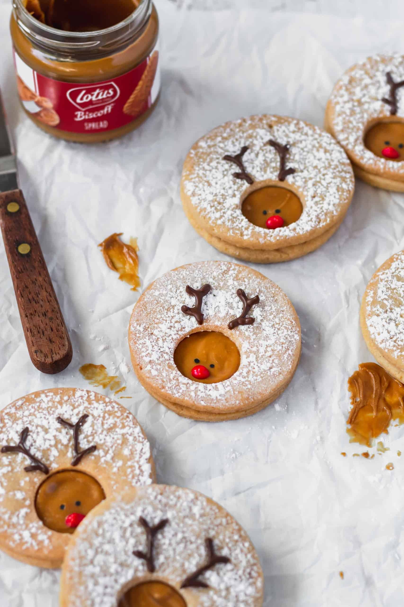 Rudolph cookies scattered on a piece of parchment paper.
