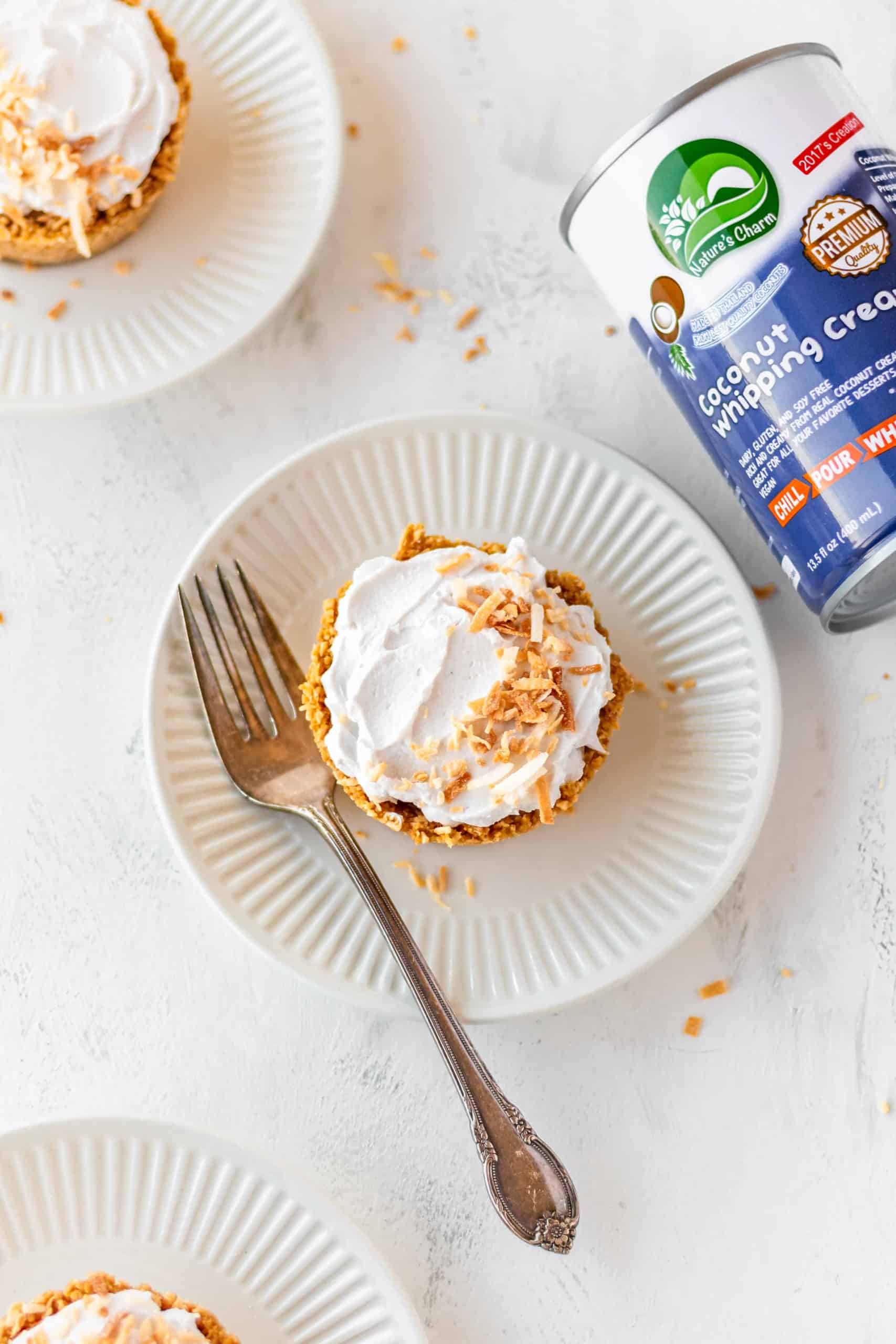 Vegan coconut cream pie on a plate with a fork