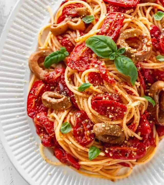 Plate of pasta with roasted tomatoes and vegan calamari