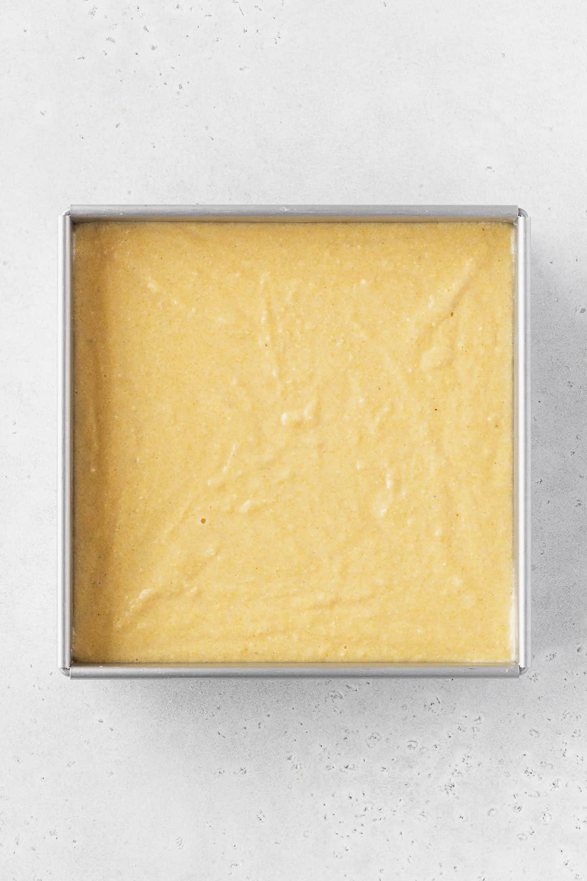 DF GF cornbread batter added to prepared baking tin.