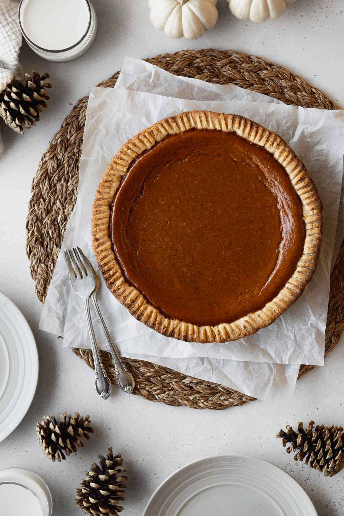 Overhead shot of non-dairy pumpkin pie on a couple pieces of crinkled parchment paper.