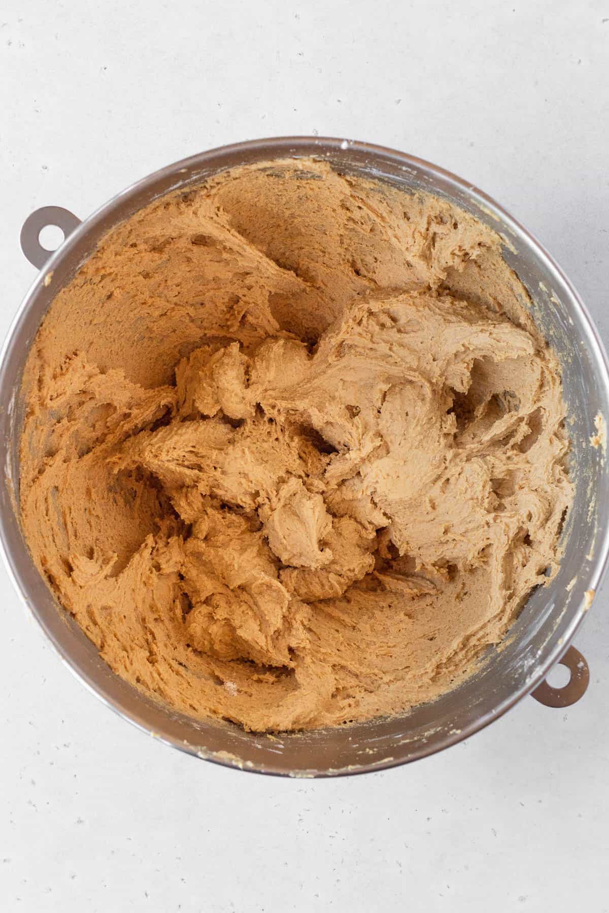 Ginger cookie dough in a metal bowl.