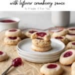 Vertical pin of gluten-free thumbprint cookies on a plate.