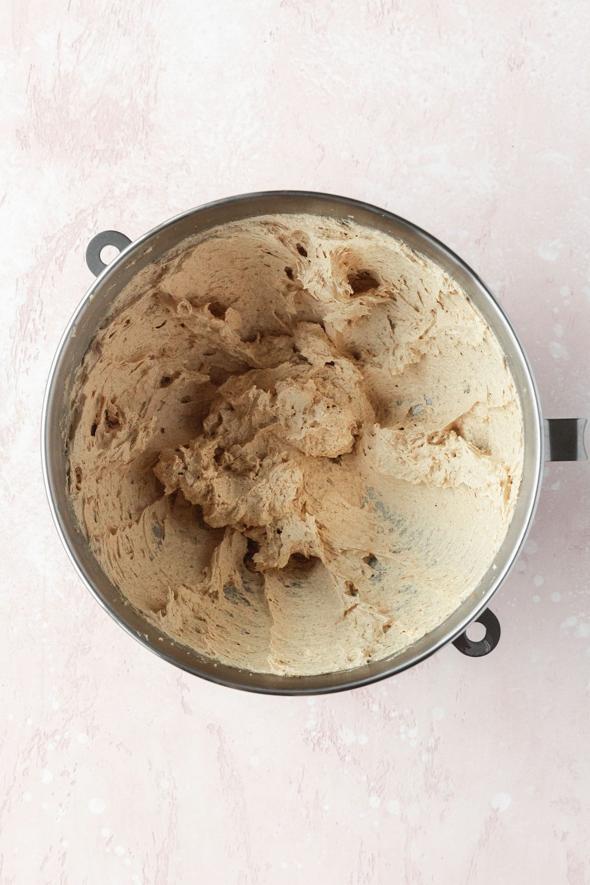 Wet ingredients to make double chocolate cookies in a silver bowl.