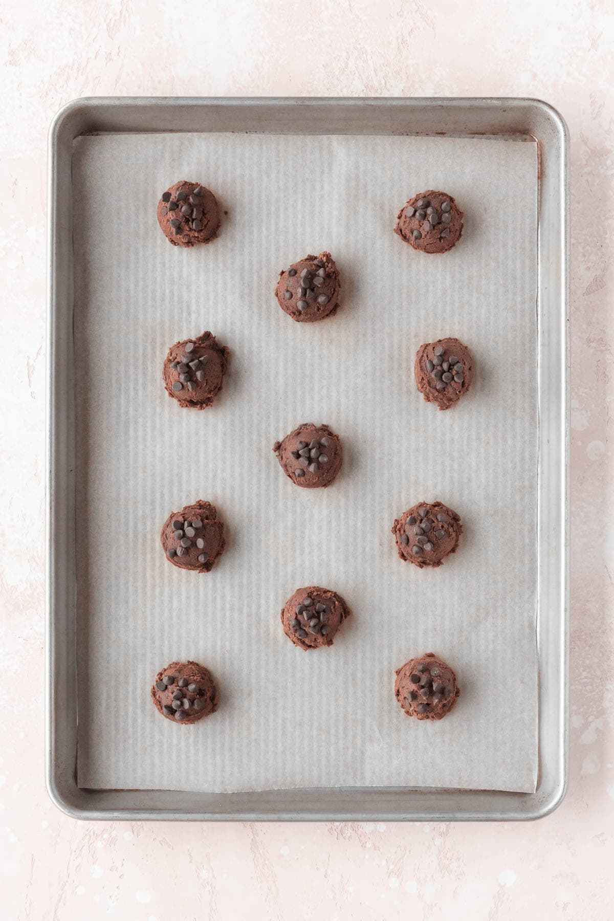 Chocolate cookie dough laid out on a baking sheet.