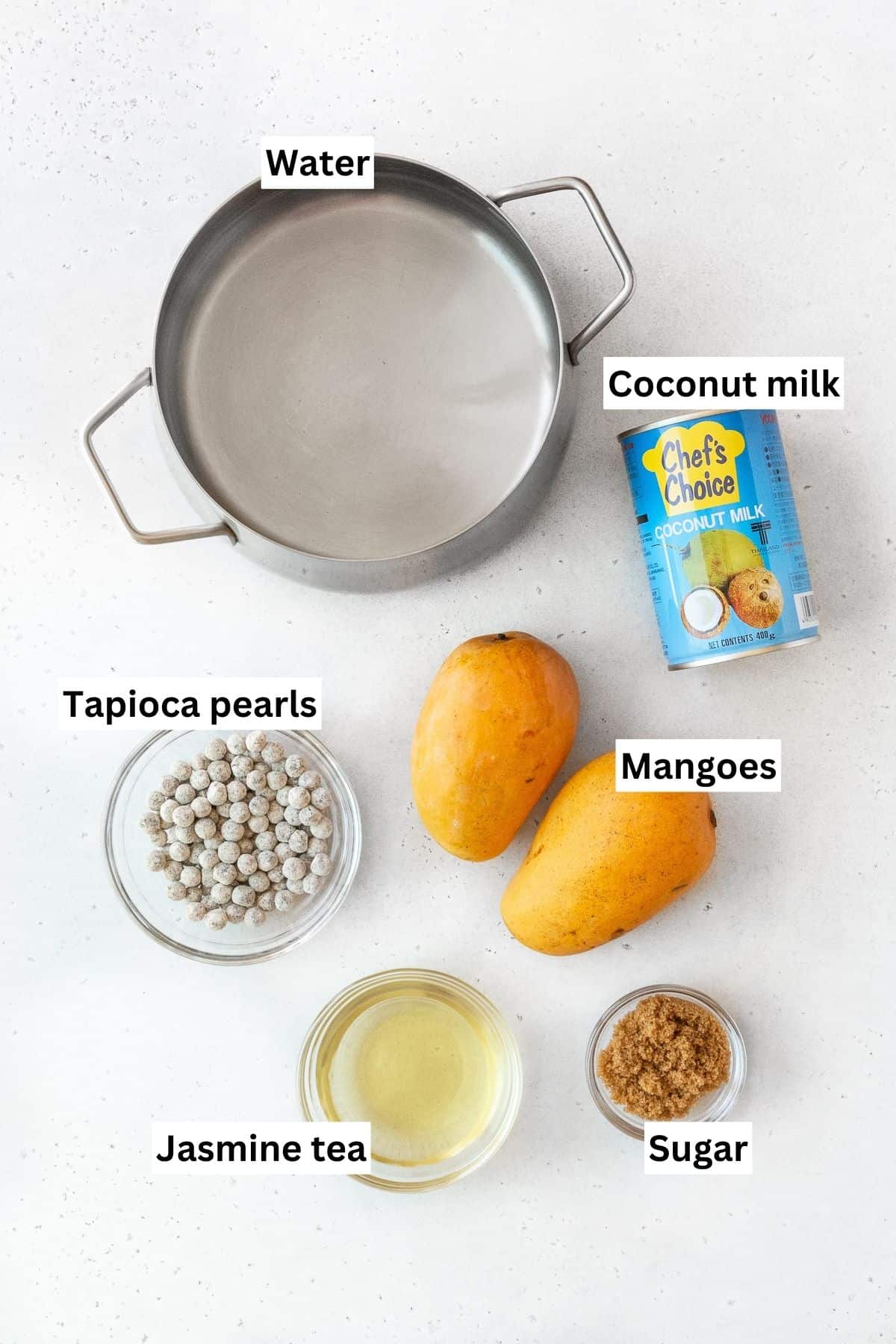All of the ingredients for mango boba tea on the counter.