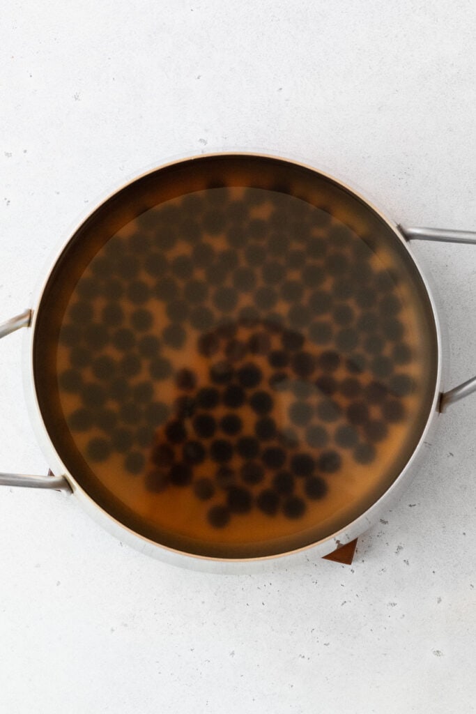 Cooking boba pearls in a large pot.