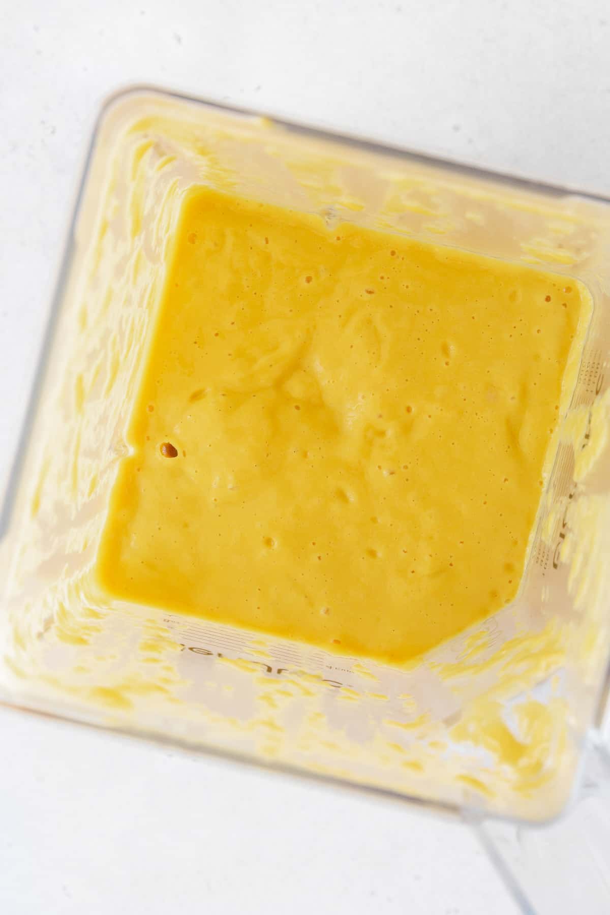 Blended up mango puree in a blender.