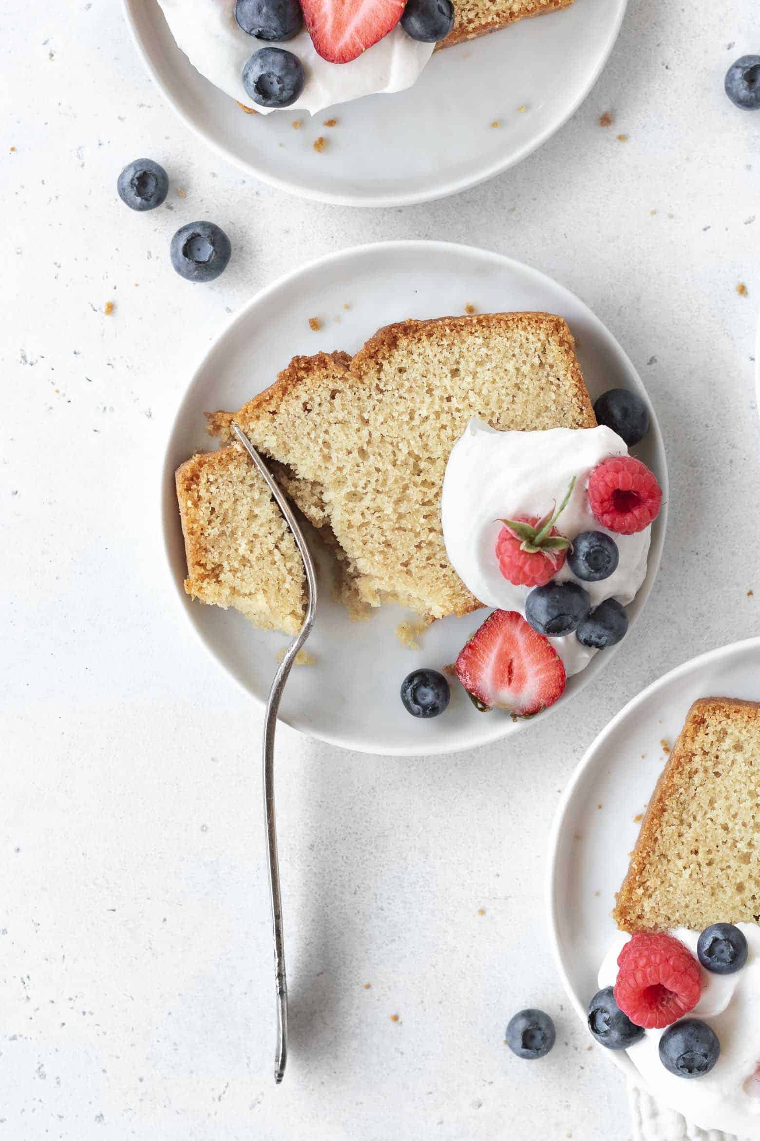 A fork cutting into a slice of pound cake.