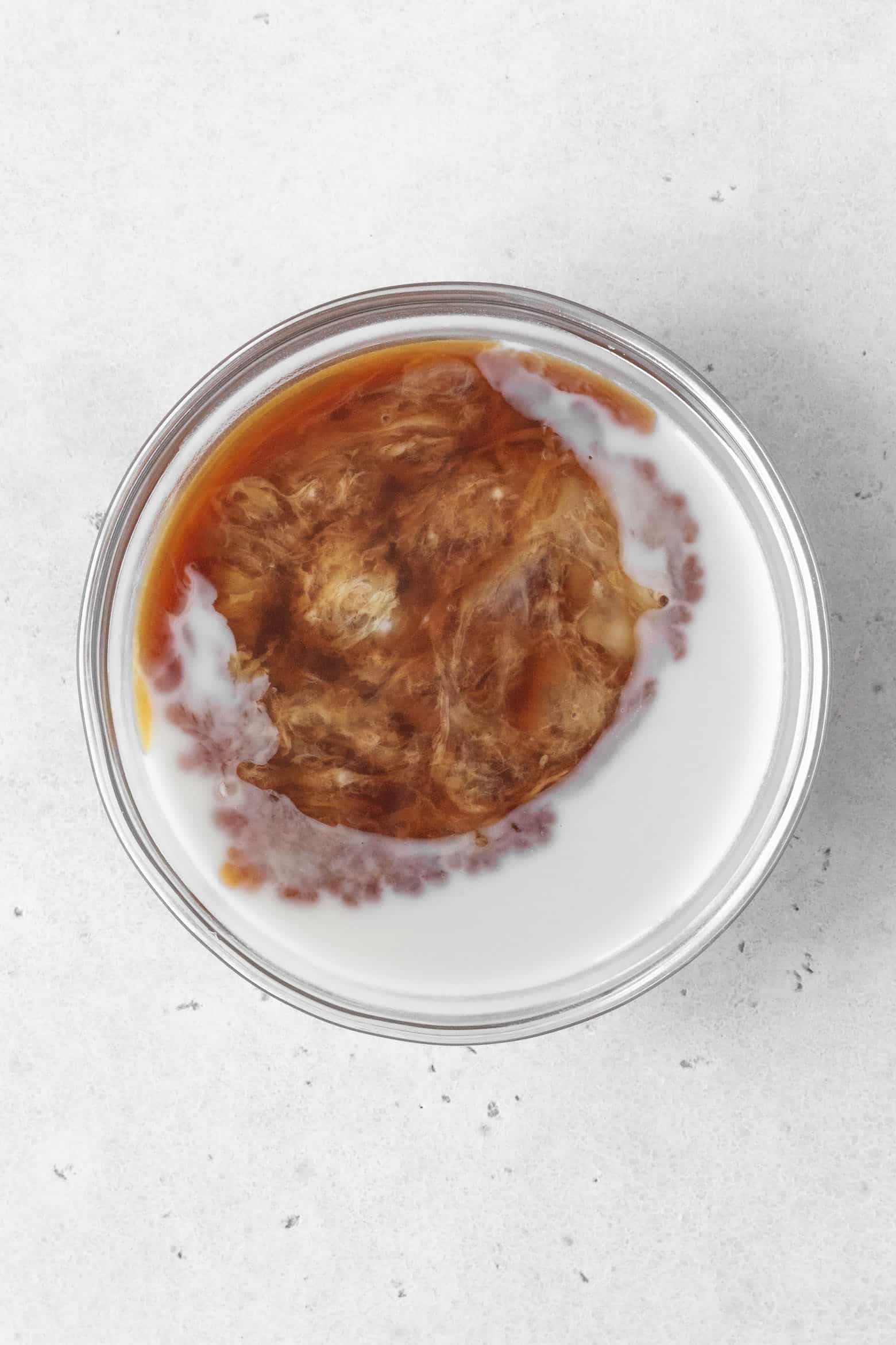 Add vanilla extract and vinegar to milk in a bowl.