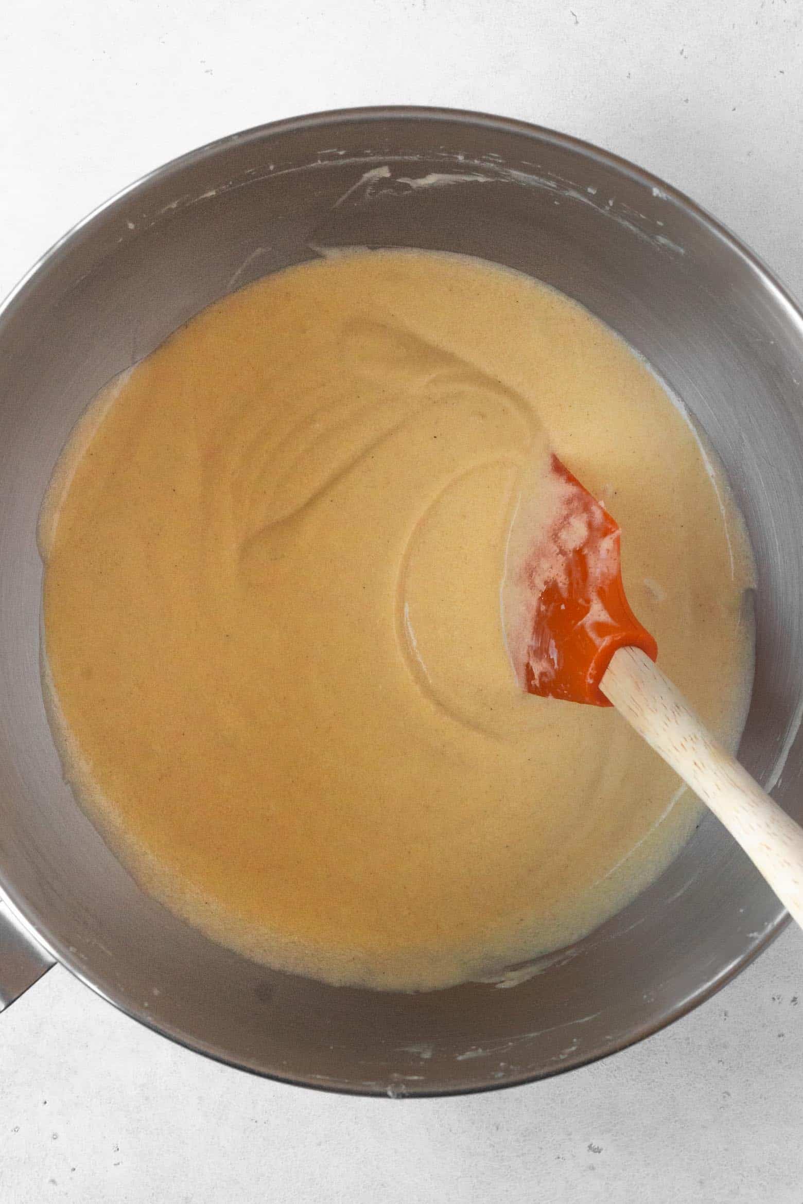Scrape the sides of the bowl to make sure the pound cake batter is homogenous.