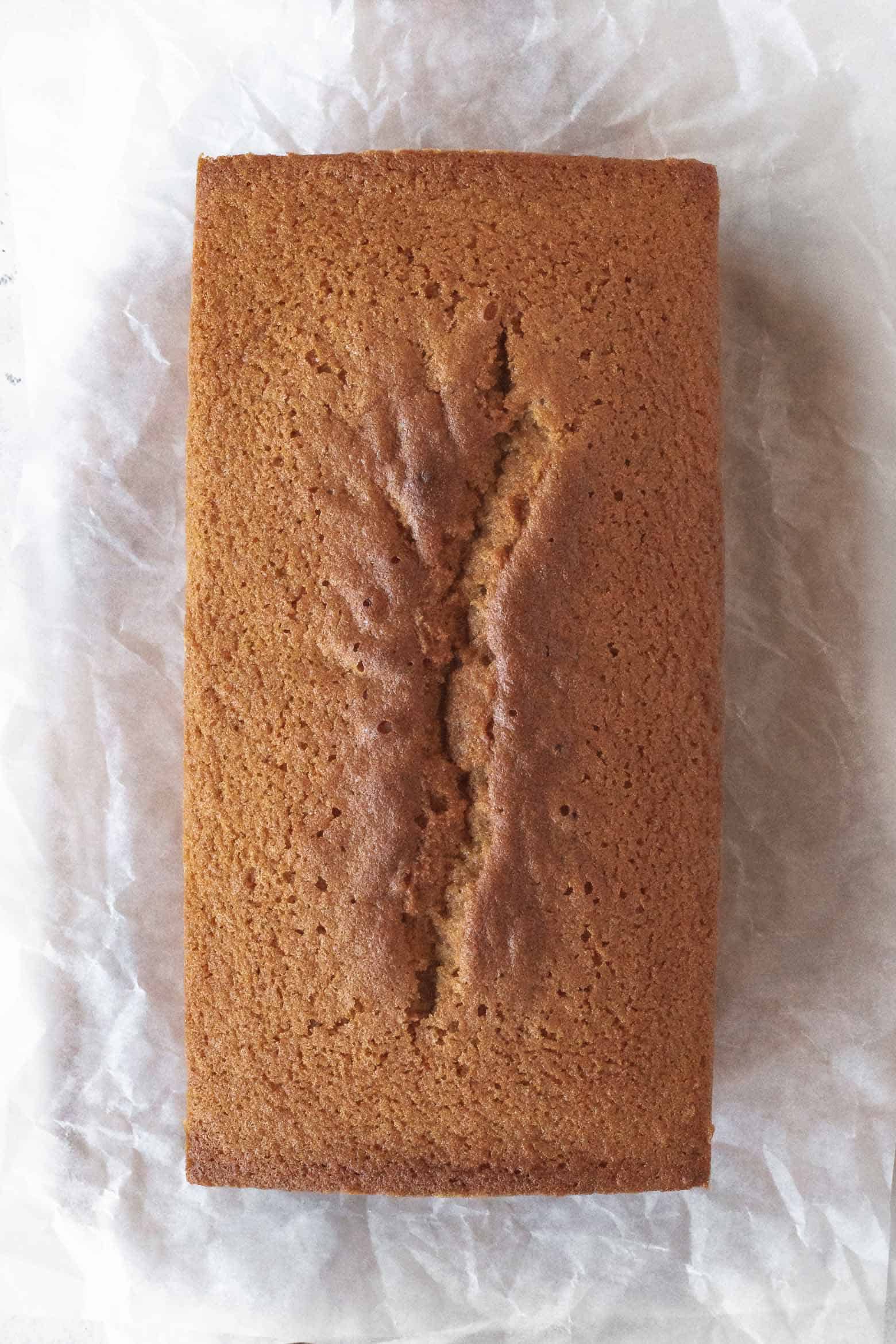 Pound cake cooling on parchment paper.